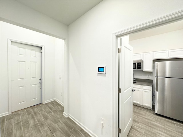 1147 Pomelo St, Davenport, FL 33837 - hall featuring wood finish floors and baseboards