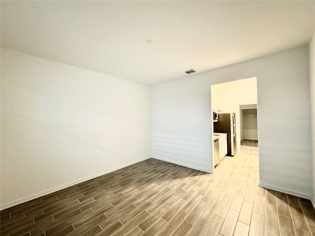 1147 Pomelo St, Davenport, FL 33837 - unfurnished room with wood finished floors and baseboards