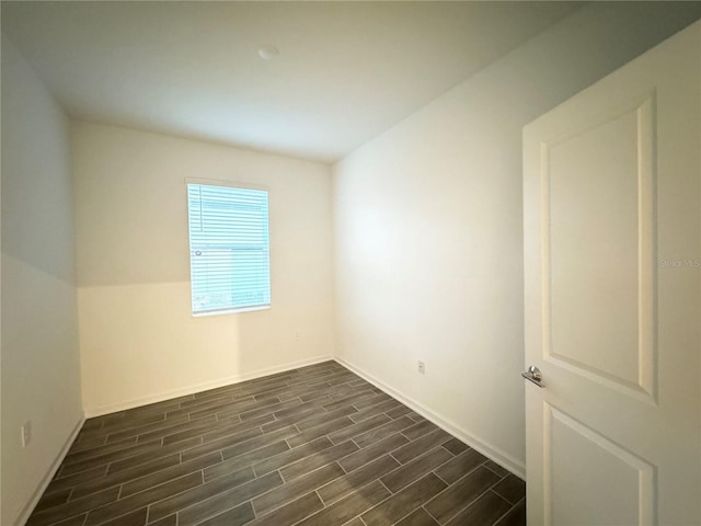1147 Pomelo St, Davenport, FL 33837 - spare room with dark wood-style flooring and baseboards