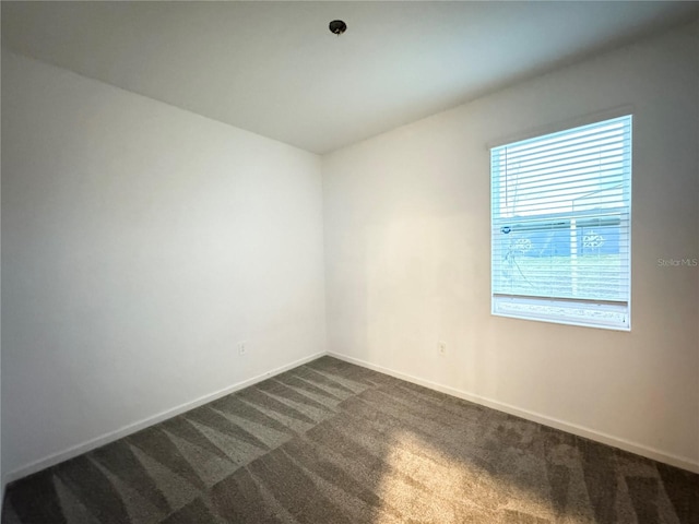 1147 Pomelo St, Davenport, FL 33837 - spare room with dark colored carpet and baseboards