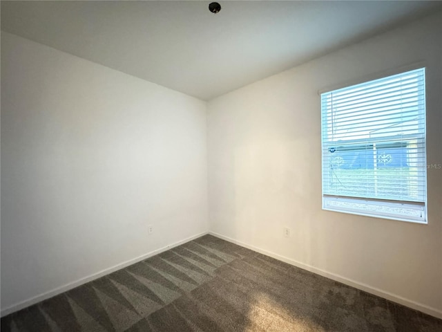 1147 Pomelo St, Davenport, FL 33837 - unfurnished room featuring dark colored carpet and baseboards