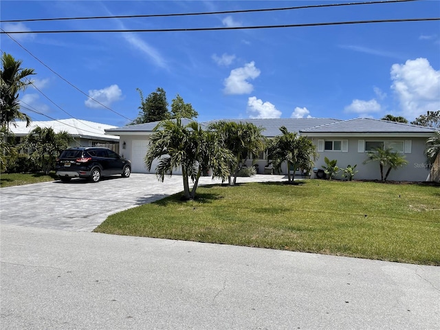 1120 SE 6th Ter, Pompano Beach, FL 33060 - ranch-style house featuring concrete driveway, a front lawn, a garage, and stucco siding
