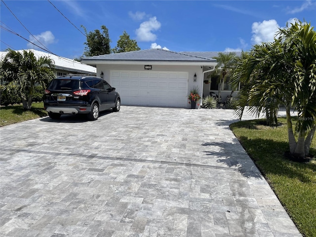1120 SE 6th Ter, Pompano Beach, FL 33060 - ranch-style home with decorative driveway, a garage, and stucco siding