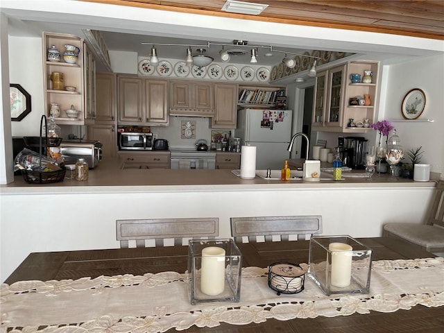 1120 SE 6th Ter, Pompano Beach, FL 33060 - kitchen featuring open shelves, white appliances, a peninsula, and glass insert cabinets