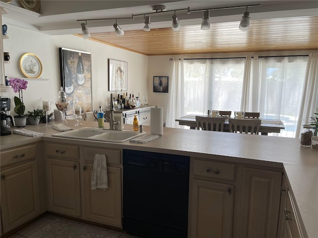 1120 SE 6th Ter, Pompano Beach, FL 33060 - kitchen with black dishwasher, rail lighting, light countertops, light tile patterned floors, and a peninsula