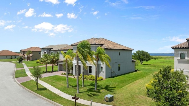 1551 Gateway Ln, Kissimmee, FL 34746 - view of front facade featuring a front lawn, a residential view, stucco siding, and a tile roof