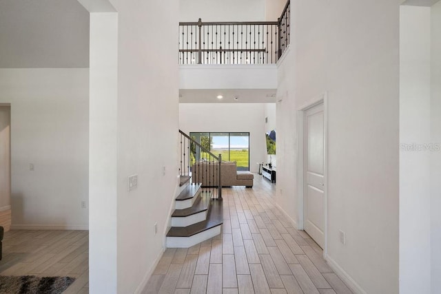 1551 Gateway Ln, Kissimmee, FL 34746 - foyer with light wood-type flooring, stairs, and a towering ceiling