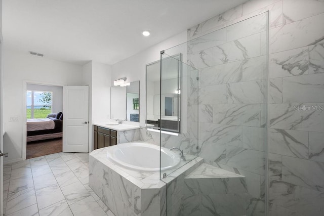 1551 Gateway Ln, Kissimmee, FL 34746 - ensuite bathroom with a bath, vanity, marble look tile flooring, and recessed lighting