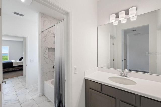 1551 Gateway Ln, Kissimmee, FL 34746 - bathroom featuring marble look tile flooring, vanity, shower / bathtub combination with curtain, and ensuite bath