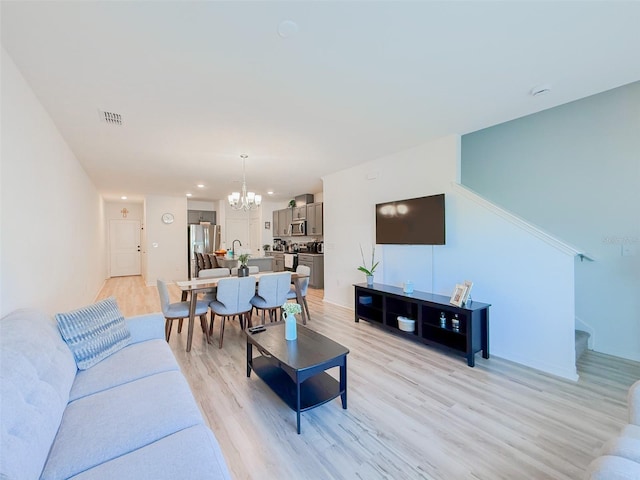 1471 Mirabella Cir, Davenport, FL 33897 - living room featuring a chandelier, light wood-style floors, recessed lighting, stairway, and baseboards