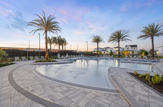 1667 Eaglehurst Ln, Apopka, FL 32703 - pool at dusk with a community pool and a patio
