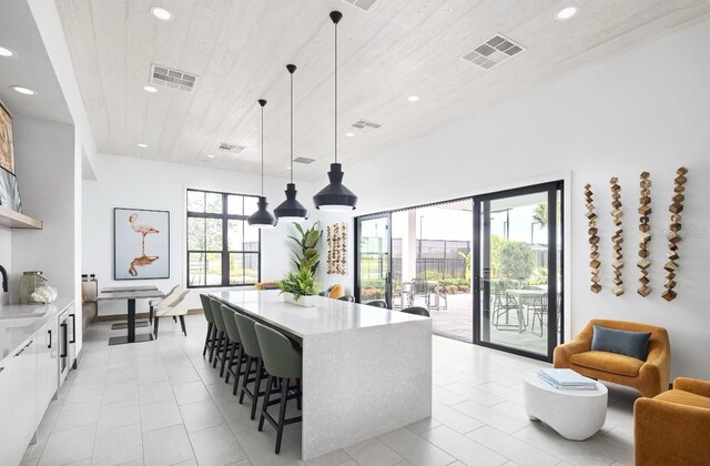1667 Eaglehurst Ln, Apopka, FL 32703 - kitchen featuring recessed lighting, light countertops, a kitchen bar, a kitchen island, and white cabinetry