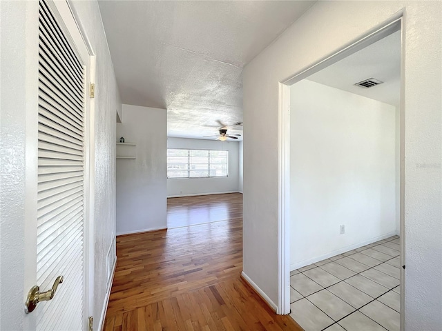 249 Spartan Dr, Maitland, FL 32751 - corridor with wood finished floors, a textured ceiling, and a heating unit