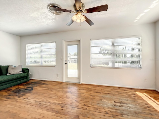 249 Spartan Dr, Maitland, FL 32751 - living room featuring light wood-type flooring, a ceiling fan, and a textured ceiling