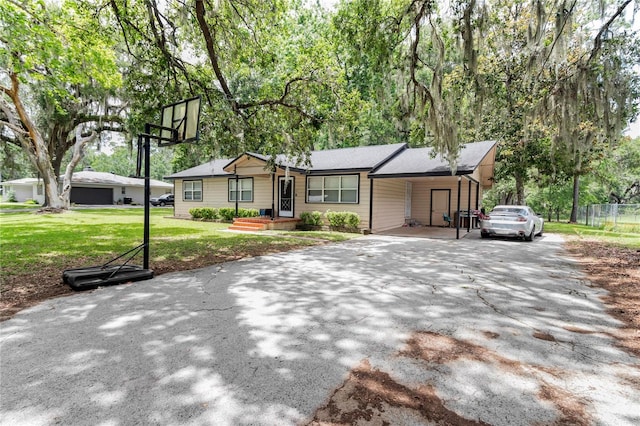 1753 NW 44th St, Ocala, FL 34475 - ranch-style house with asphalt driveway and a carport