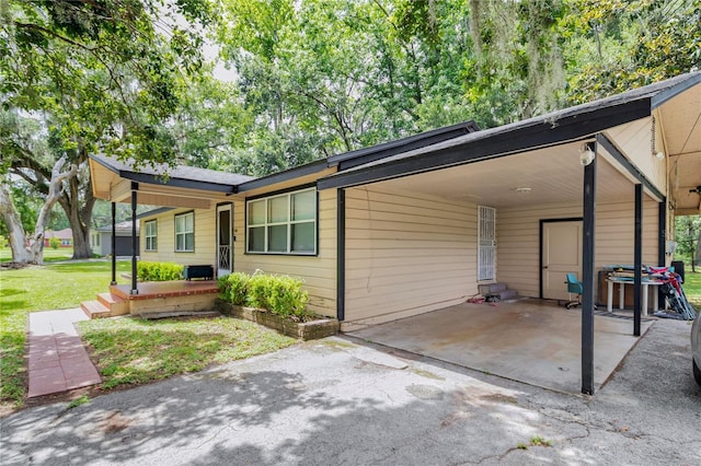 1753 NW 44th St, Ocala, FL 34475 - view of front of property with a carport, a front yard, and driveway