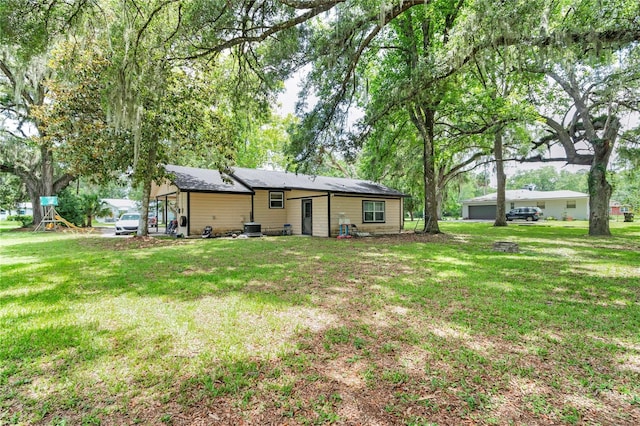 1753 NW 44th St, Ocala, FL 34475 - rear view of house with a lawn