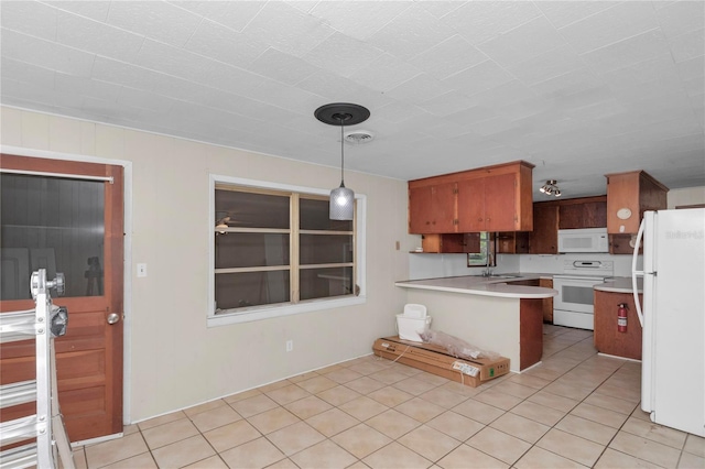 1753 NW 44th St, Ocala, FL 34475 - kitchen with white appliances, light countertops, a peninsula, a sink, and decorative light fixtures