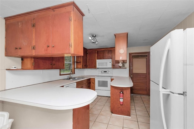 1753 NW 44th St, Ocala, FL 34475 - kitchen featuring white appliances, light countertops, a peninsula, light tile patterned floors, and a sink