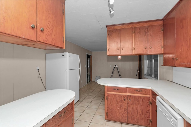 1753 NW 44th St, Ocala, FL 34475 - kitchen with white appliances, light countertops, a peninsula, and light tile patterned floors