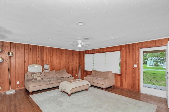 1753 NW 44th St, Ocala, FL 34475 - living room featuring a ceiling fan, wood finished floors, wood walls, and baseboards