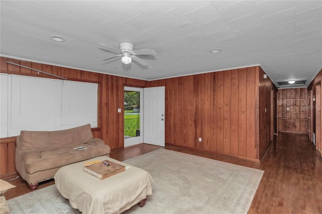 1753 NW 44th St, Ocala, FL 34475 - sitting room with wooden walls, wood finished floors, a ceiling fan, and baseboards