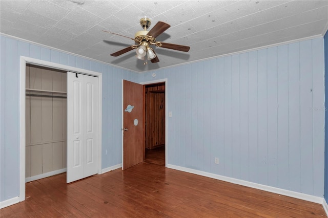 1753 NW 44th St, Ocala, FL 34475 - unfurnished bedroom featuring wood finished floors, baseboards, a closet, a ceiling fan, and crown molding