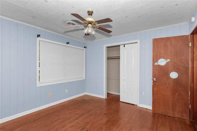 1753 NW 44th St, Ocala, FL 34475 - unfurnished bedroom with hardwood / wood-style floors, baseboards, a closet, ceiling fan, and crown molding