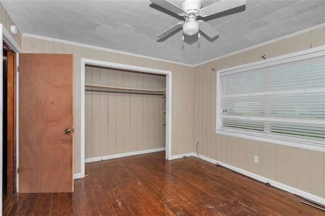 1753 NW 44th St, Ocala, FL 34475 - unfurnished bedroom featuring wood-type flooring, crown molding, a closet, baseboards, and a ceiling fan