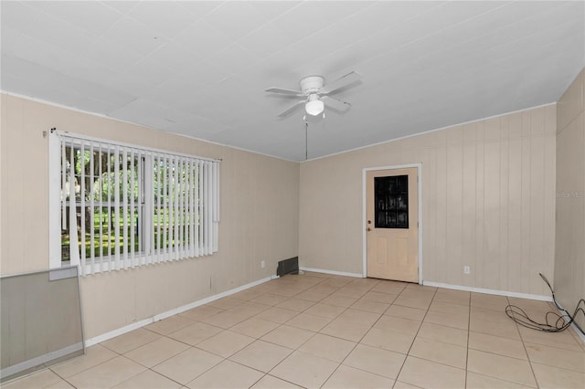 1753 NW 44th St, Ocala, FL 34475 - tiled spare room featuring ceiling fan, baseboards, and wooden walls