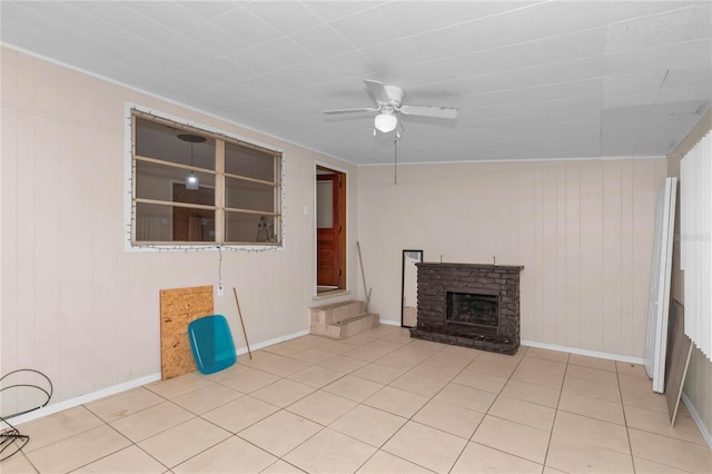 1753 NW 44th St, Ocala, FL 34475 - unfurnished living room featuring a ceiling fan, tile patterned floors, a fireplace, baseboards, and wooden walls