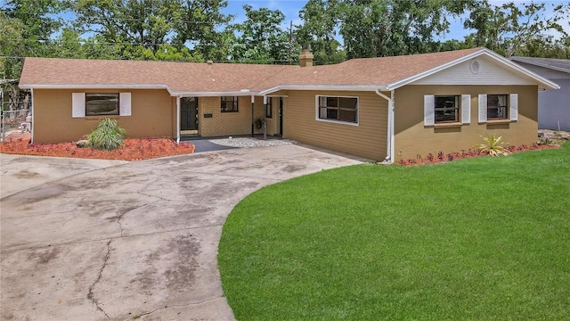 2804 Clearfield Ave, Orlando, FL 32808 - single story home featuring a front lawn, concrete driveway, roof with shingles, and a chimney