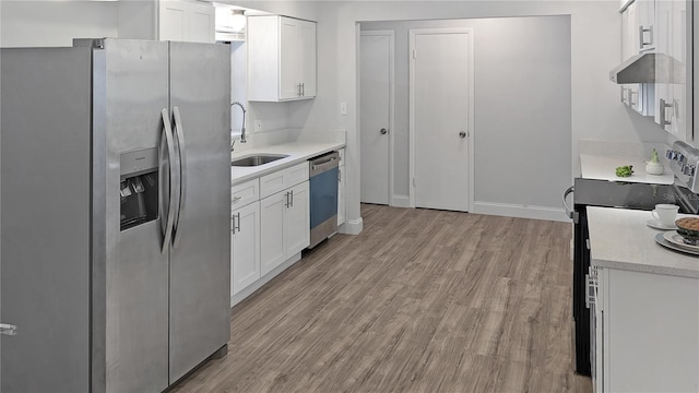 2804 Clearfield Ave, Orlando, FL 32808 - kitchen with appliances with stainless steel finishes, light wood-type flooring, white cabinets, light stone countertops, and ventilation hood