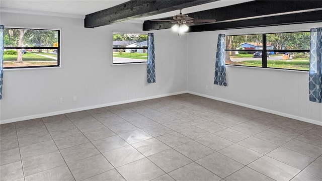 2804 Clearfield Ave, Orlando, FL 32808 - tiled empty room featuring healthy amount of natural light, beam ceiling, and ceiling fan