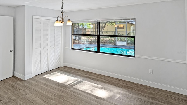 2804 Clearfield Ave, Orlando, FL 32808 - unfurnished dining area with wood finished floors and baseboards