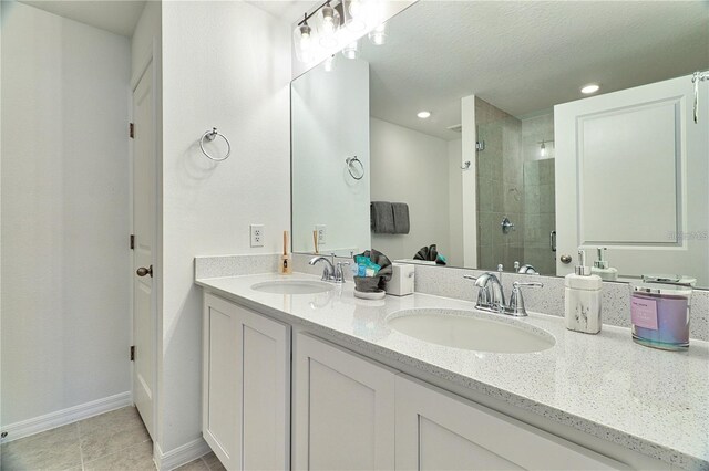 832 Longboat Dr, Davenport, FL 33896 - full bath featuring double vanity, a tile shower, tile patterned flooring, and recessed lighting