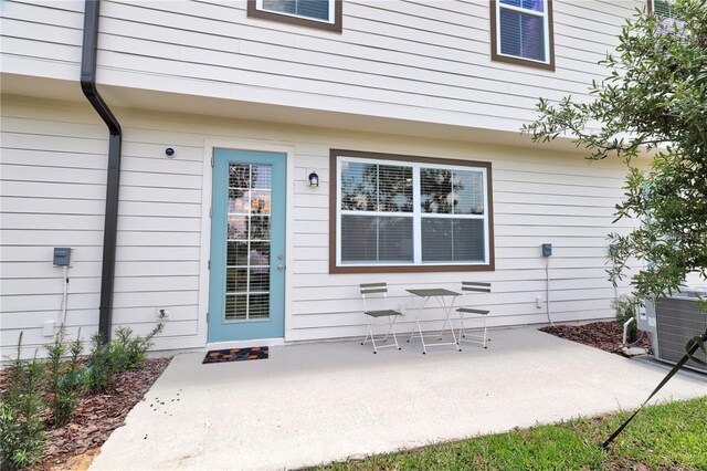 832 Longboat Dr, Davenport, FL 33896 - view of exterior entry with a patio