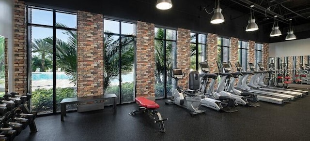 832 Longboat Dr, Davenport, FL 33896 - gym with a towering ceiling and brick wall