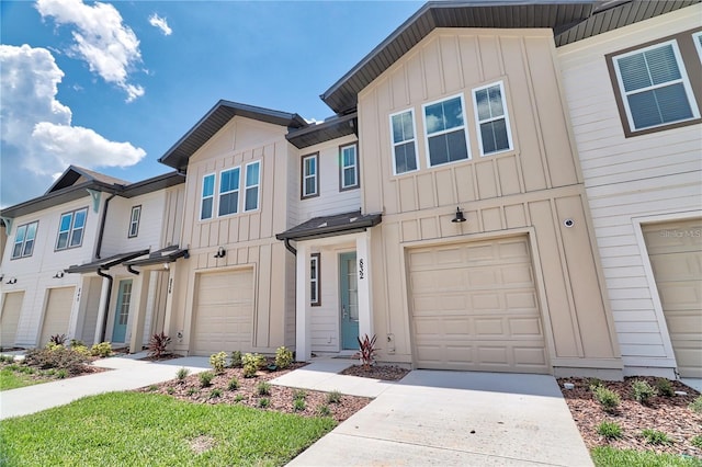 832 Longboat Dr, Davenport, FL 33896 - view of property with board and batten siding, driveway, and a garage