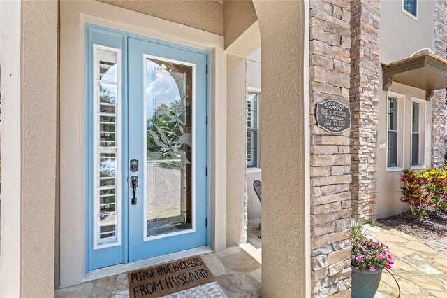 25537 High Hampton Cir, Sorrento, FL 32776 - property entrance featuring stucco siding and stone siding