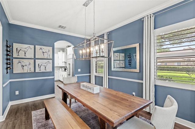 25537 High Hampton Cir, Sorrento, FL 32776 - dining room featuring a chandelier, wood finished floors, arched walkways, ornamental molding, and baseboards
