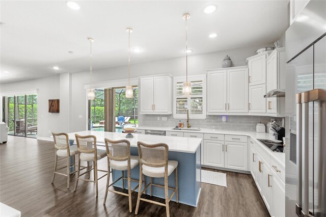 25537 High Hampton Cir, Sorrento, FL 32776 - kitchen with dark wood finished floors, black electric stovetop, a center island, light countertops, and high end fridge