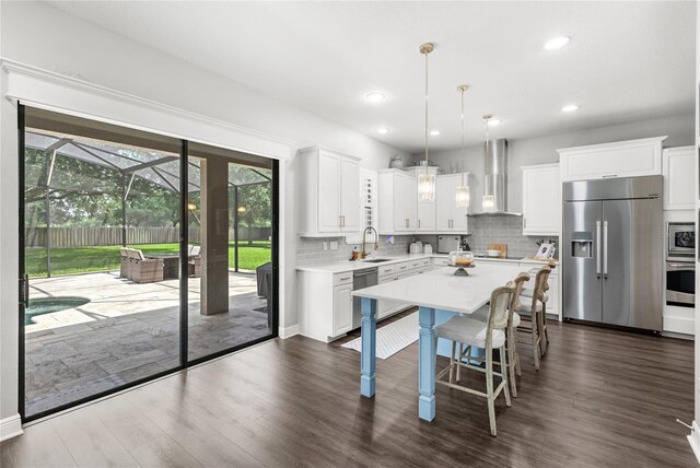 25537 High Hampton Cir, Sorrento, FL 32776 - kitchen featuring stainless steel appliances, wall chimney exhaust hood, a sink, light countertops, and backsplash
