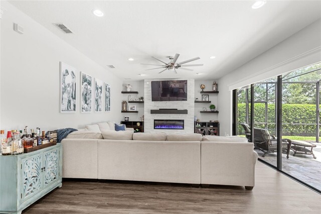 25537 High Hampton Cir, Sorrento, FL 32776 - living room with recessed lighting, a ceiling fan, a large fireplace, and wood finished floors
