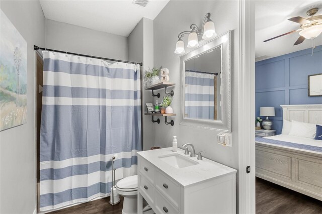 25537 High Hampton Cir, Sorrento, FL 32776 - full bath featuring wood finished floors, vanity, a ceiling fan, toilet, and curtained shower
