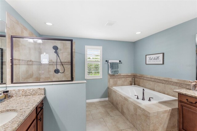 25537 High Hampton Cir, Sorrento, FL 32776 - bathroom with vanity, a garden tub, tiled shower, tile patterned flooring, and baseboards