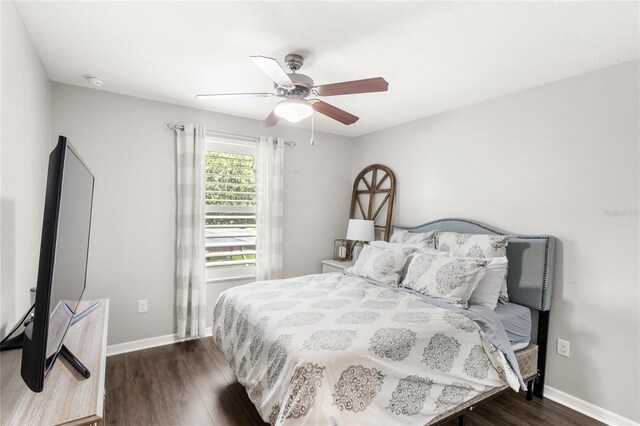 25537 High Hampton Cir, Sorrento, FL 32776 - bedroom with dark wood-style flooring, baseboards, and a ceiling fan