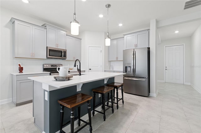 2279 Mountain Pine St, Ocoee, FL 34761 - kitchen featuring appliances with stainless steel finishes, light countertops, a kitchen island with sink, recessed lighting, and a breakfast bar