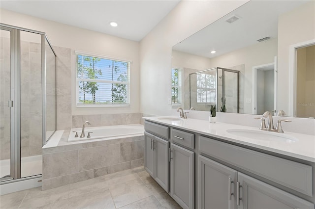 2279 Mountain Pine St, Ocoee, FL 34761 - full bathroom featuring double vanity, a shower stall, a garden tub, tile patterned flooring, and recessed lighting