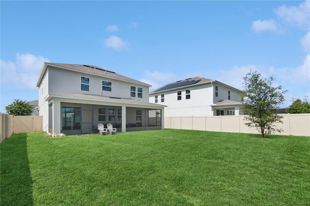 2279 Mountain Pine St, Ocoee, FL 34761 - rear view of property with a sunroom, solar panels, a fenced backyard, a shingled roof, and stucco siding